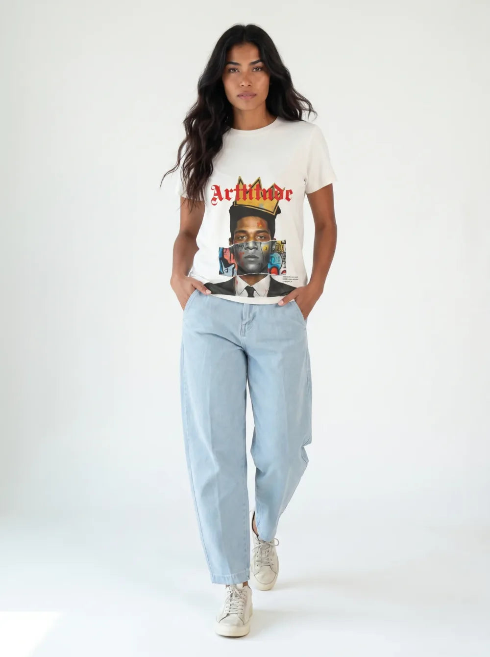 White cropped tee with a colour portrait print, light-wash barrel jeans, white sneakers, caught mid-stride