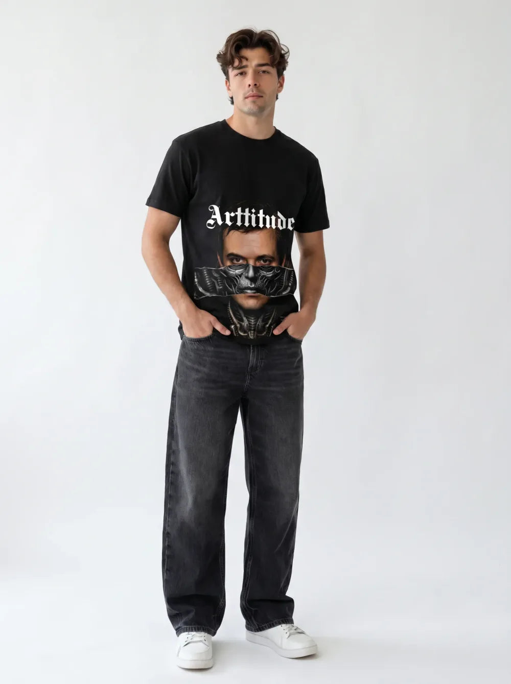 Black tee with a monochrome portrait print, metallic mask over the mouth, charcoal jeans, white sneakers